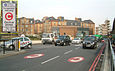 Street markings and a sign (inset) with the white-on-red C alert drivers to the charge