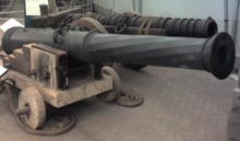 Two large metal cannons of differing designs, one in front of the other