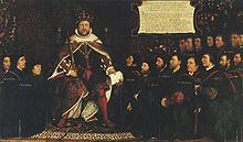 King Henry VIII in full royal regalia surrounded by a kneeling group of men who are all wearing black clothing and some with matching close-fitting caps