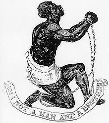 Drawing which shows a slave kneeling and holding up his clasped and manacled hands. Underneath him, a banner says 