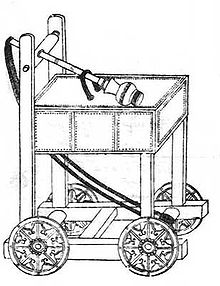 An ink on paper diagram of a trebuchet. A long arm with a spherical cap rests on top of a large square platform. The square platform is supported by four plain cut square beams, which connect to an open undercarriage. Rope hangs between the end of the pole that does not have the cap to the inside of the undercarriage, as far away from the start of the rope as possible. The assembly moves on four wheels attached to the sides of the undercarriage.