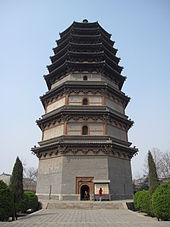 A wide, octagonal pagoda. It has four tall, functional floors made of brick, and an additional five, short, purely decorative floors made of wood. Each floor is separated by an eave, and the top five floor's eaves look as if they were simply stacked right on top of one another.